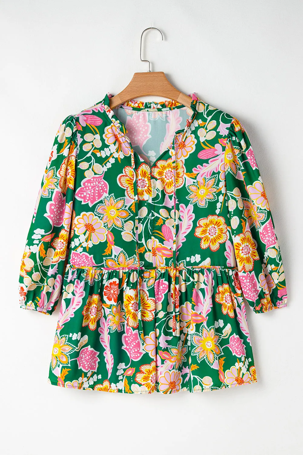 Chemisier péplum vert à manches bouffantes et col en V à fleurs